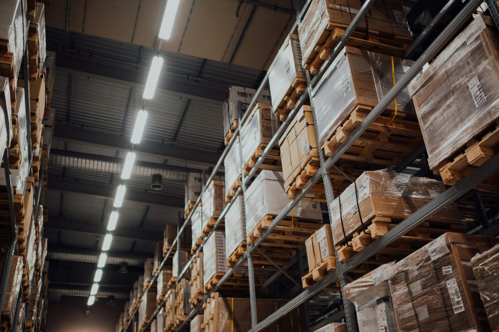 Rows of shipping pallets and boxes in a warehouse, representing wholesale supply at Form Supply Co