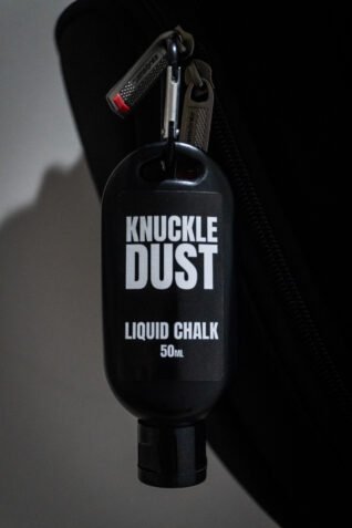 liquid chalk by Knuckledust 50ml bottle attached to a gym backpack