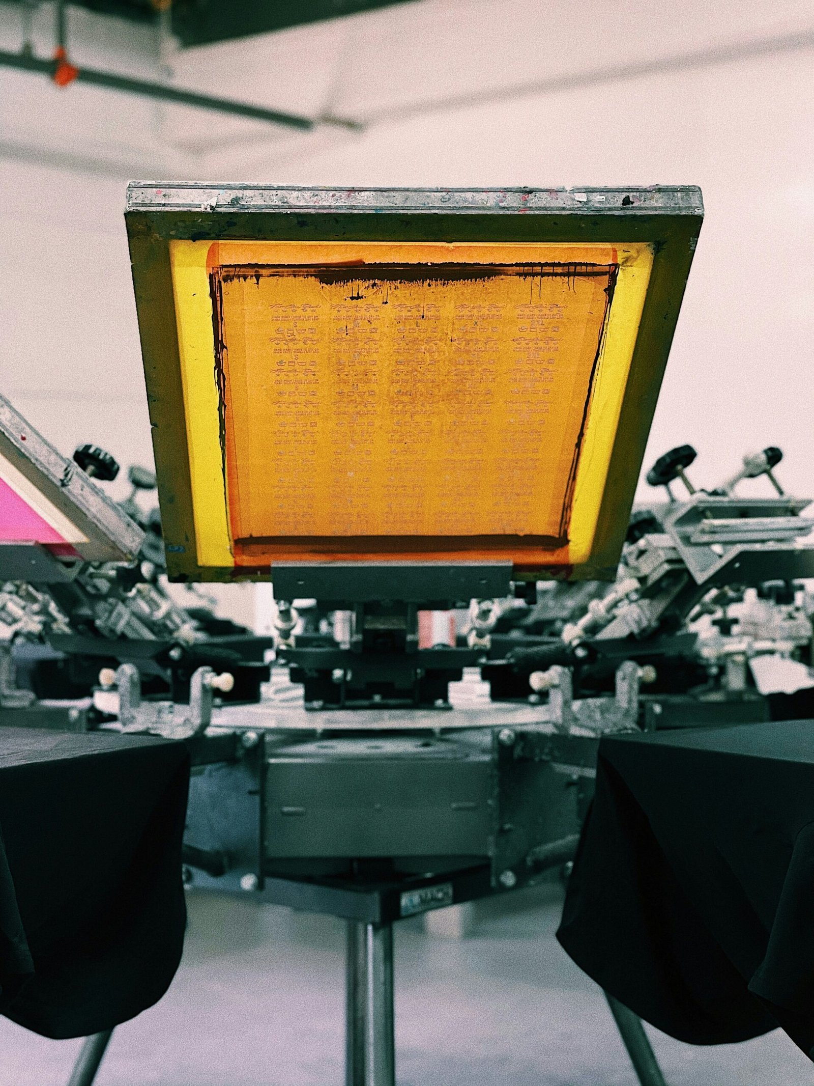 Close-up of screen printing press for custom apparel at Form Supply Co
